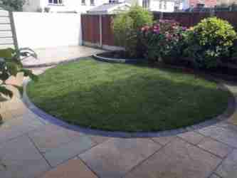 Image of a Curved turf lawn and yellow limestone paving