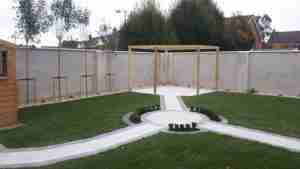  image of newly constructed Pergola patio and tree screening with box hedging to surround of circular paving
