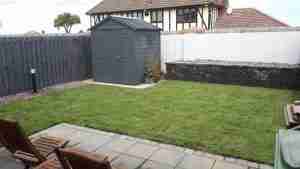 Image of th enew garden with raised beds, bollard lighting turf lawn and brick and gravel edging