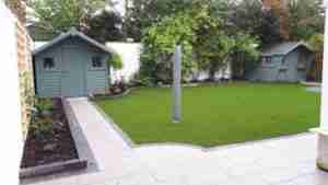 Image of new path and artificial lawn raised beds and garden space