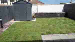 Image of New raised bed with lighting new turf lawn and brick and gravel edging in the garden