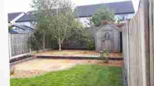 Image of new terraced garden with gravel surfacing,limestone paving and birch tree