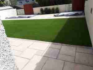 Concrete pads for steel sheds installed with paving and artificial lawn