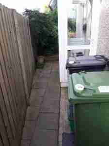 Side passage area, old concrete and paving.