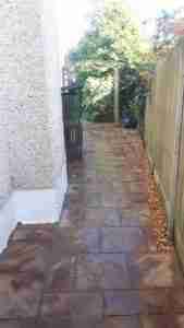 Image of new paving to side of house with gravel border for drainage