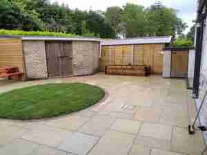 Yellow limestone patio with circular lawn