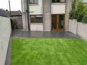 Lush looking artificial lawn and contemporary soft grey composite deck