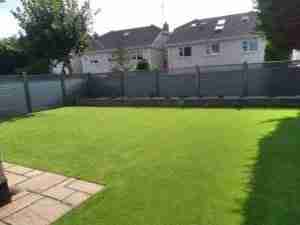 image of Elite fence, a low maintenance fence artificial lawn and Connemara walling raised bed