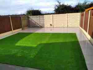View of more spacious garden with easy to keep lawn and patio