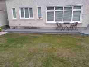 Image of composite decking over concrete path to side of house
