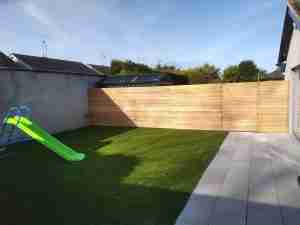 Image of New artificial lawn and larch screening