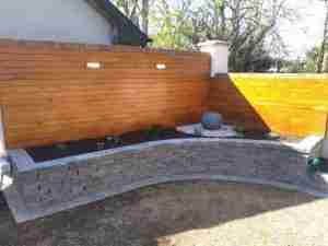 Image of New Garden feature with Larch Cladding and lighting, water feature and planting