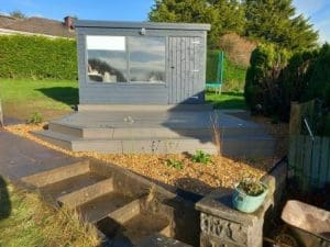 Composite decking with lights and gravel surround and plants