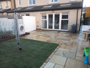 View to house of new paving and lawn