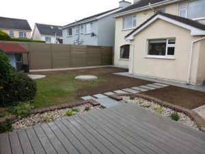 Garden redesigned with new pvc fencing, porcelain paving, composite decking and seeded lawn